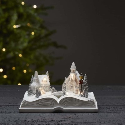 Julby öppen bok med kyrka och hus vit