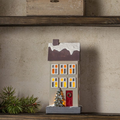 Juldekoration Beige hus med ljus i fönstren batteridriven